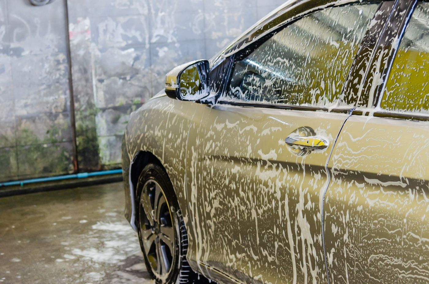 A car covered in wash foam during an exterior wash
