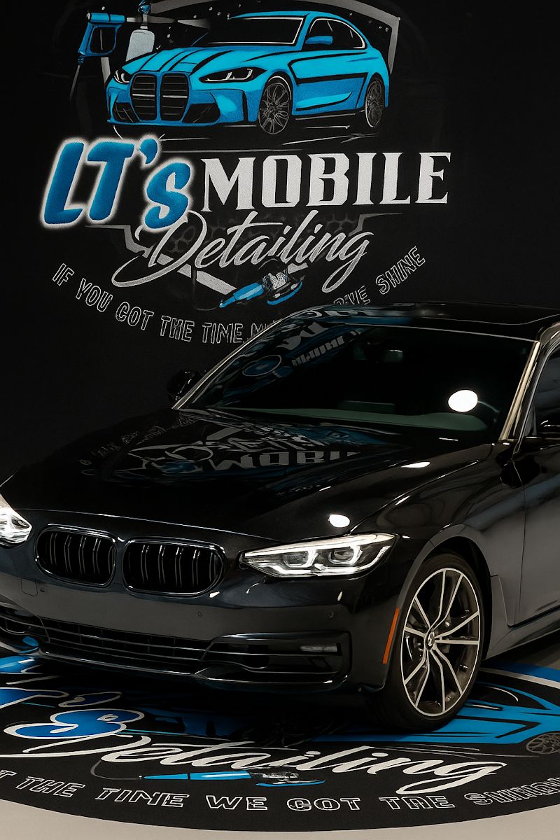 A black BMW sedan detailed by LT's Mobile Detailing, photographed in front of the LT's Mobile Detailing branded backdrop